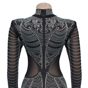 Detail of back hidden zipper and rhinestones on black mesh long sleeve bodysuit