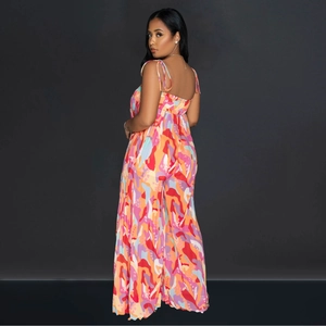 Detail of multi-color abstract print jumpsuit featuring adjustable spaghetti straps and back smocking