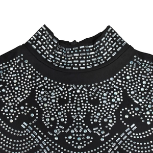 Detail of high neck black mesh dress with sparkling geometric rhinestone patterns