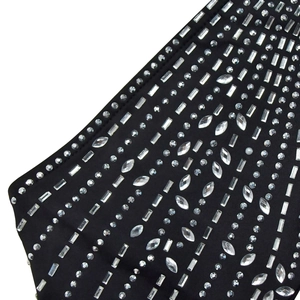 Détail macro de cristaux de strass sur le tissu d'une combinaison noire