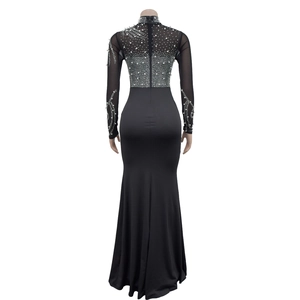 Detail of sheer mesh back with pearl and rhinestone embellishments on a black maxi dress
