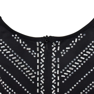 Detail of V-shaped rhinestone patterns and back invisible zipper on black jumpsuit