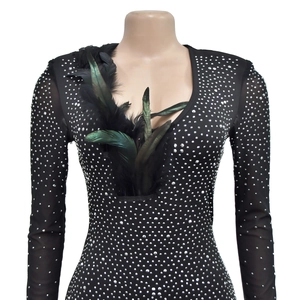 Detail of black party dress featuring silver rhinestones and faux emerald feather neckline