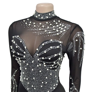 Detail of sheer mesh jumpsuit with white pearls and sparkling rhinestones in wavy patterns