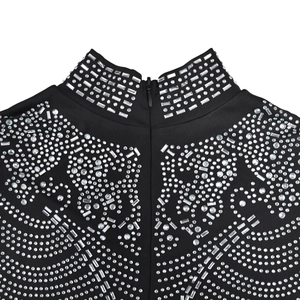 Macro detail of high collar with silver rhinestones and concealed back zipper on black mesh dress