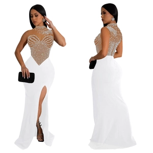 Detail of elegant white mesh evening dress with silver rhinestone heart pattern and slit