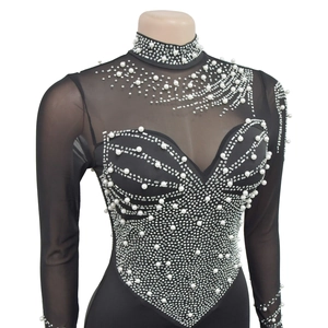 Detail of sheer black mesh bodysuit with pearls and sparkling rhinestones decoration
