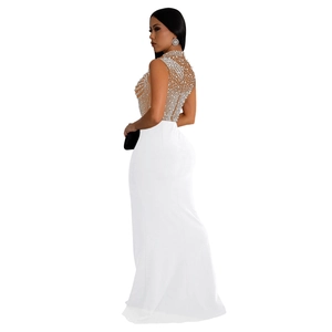 Detailed view of white mesh evening gown with intricate pearl and rhinestone embroidery