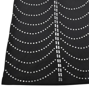 Close-up of sparkling silver rhinestones in a circular pattern on black mesh fabric
