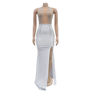 Close-up of white sleeveless evening dress with silver rhinestones and high slit