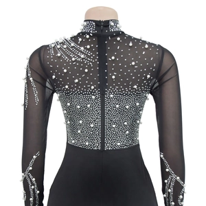 Detail of sheer black mesh bodysuit with intricate pearl and rhinestone patterns on the back
