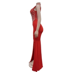 Detail of red fishtail dress featuring white pearls and rhinestone bodice embellishments