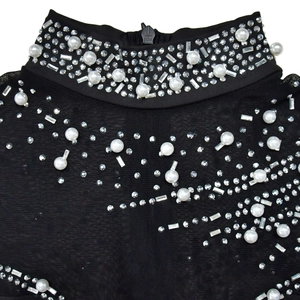 Detail of high neck mesh dress featuring elegant pearls and sparkling rhinestone embellishments