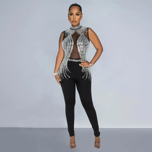 Detail of elegant black mesh jumpsuit featuring intricate silver rhinestone patterns