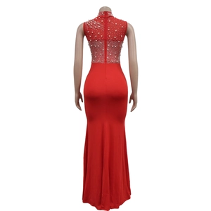 Detail of red evening dress featuring sheer mesh back with white pearls and rhinestones