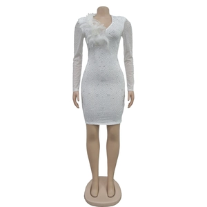 Close-up of white mesh sleeve with sparkling rhinestones and elegant feather trim detail