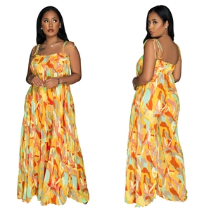 Detail of pleated wide-leg jumpsuit featuring vibrant abstract floral print and thin straps
