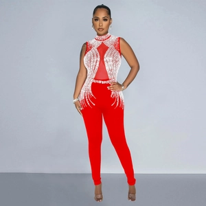 Close-up of red slim fit jumpsuit featuring mesh patchwork and sparkling rhinestone patterns
