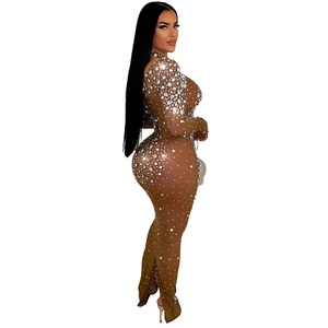 Close-up of mesh fabric featuring sparkling rhinestones on long-sleeved dress