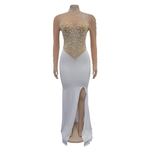 Detail of white mesh dress featuring elegant pearls, sequins and a high side slit