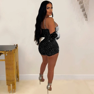 Detail of black mesh romper with shimmering rhinestones and matching arm sleeves