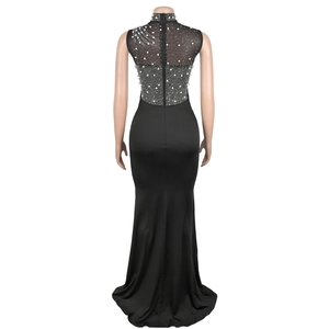Detail of black mesh back evening dress with white pearls and sparkling rhinestone decor