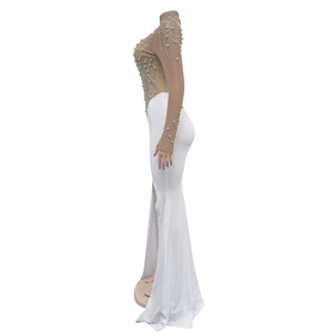 Detail of white evening dress featuring mesh sleeves with silver rhinestones and pearls