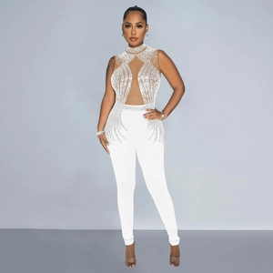 Detailed view of white sleeveless jumpsuit with rhinestones and mesh patchwork