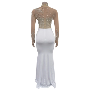 Detail of evening dress back featuring intricate white pearls and rhinestones on mesh