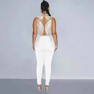 Detail of white sleeveless jumpsuit featuring sheer mesh back with shimmering silver rhinestones