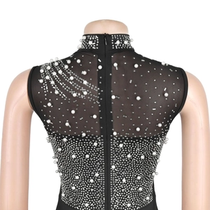 Detailed view of black sheer mesh top featuring elegant pearls and sparkling rhinestones