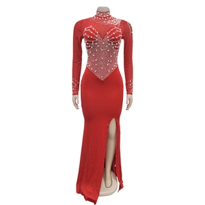 Detail view of red slim fit evening dress featuring intricate white pearl beaded patterns