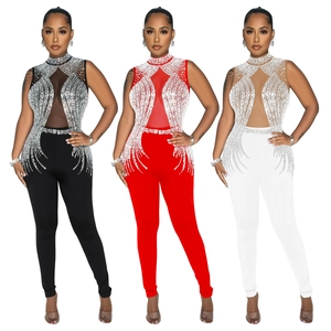 Detail of mesh paneling and rhinestone fringe on sleeveless jumpsuits in black, red, and white