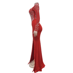 Detail of red mesh evening dress featuring white pearls and rhinestone wave patterns