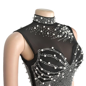 Detail of high-neck sleeveless mesh dress with intricate white pearls and rhinestone pattern