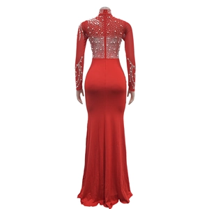 Detail of red long sleeve evening dress with mesh back and white pearls and rhinestones
