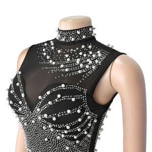 Detail of sheer mesh gown featuring intricate wave pattern with pearls and rhinestones