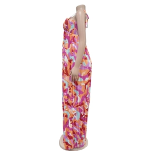 Detail of colorful abstract floral print and pleated fabric texture on the jumpsuit