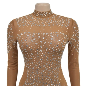 Close-up of sheer mesh high-neck bodysuit with sparkling rhinestones and crystal details
