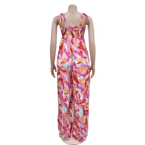Back view of printed wide-leg jumpsuit showing smocked elastic detail and tie straps