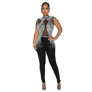 Detailed view of sheer mesh bodice with silver rhinestones on black jumpsuit