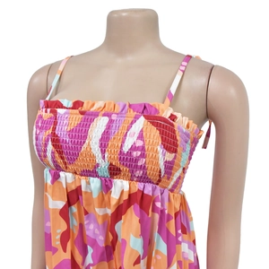 Detail of smocked bodice and spaghetti straps on women's colorful abstract jumpsuit
