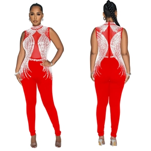 Detail of red mesh jumpsuit with sparkling rhinestone patterns and sleeveless high neck design