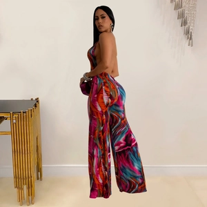 Detail view of backless halter jumpsuit featuring colorful abstract art print