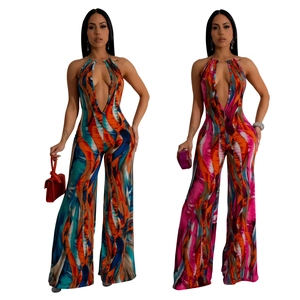 Detail of plunging neckline and abstract printed halter jumpsuit with open back