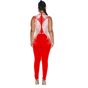Close-up of red jumpsuit back featuring sheer mesh and sparkling rhinestone patterns