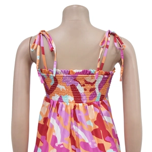 Detail view of the smocked back design and adjustable tie straps on the floral jumpsuit