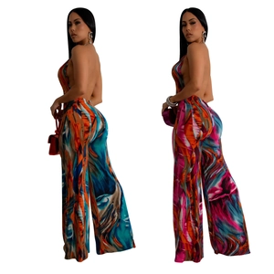 Women's backless halter jumpsuit featuring vibrant abstract print and wide-leg design
