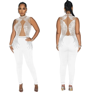 Detail of white sleeveless jumpsuit with mesh paneling and shimmering rhinestone accents
