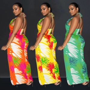 Detailed back view of backless halter maxi dresses with vibrant tropical leaf patterns